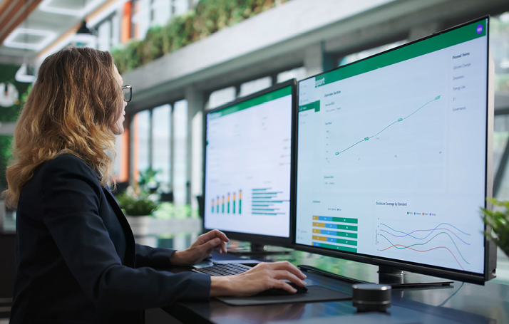 Analyst reviewing program data, reporting, and optimization dashboards